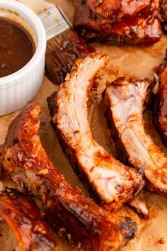 bbq ribs and barbecue sauce on a cutting board