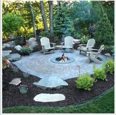 a fire pit surrounded by chairs and trees