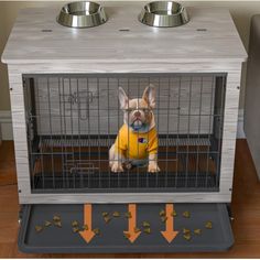 a dog in a crate with two bowls on the side and an arrow pointing to it