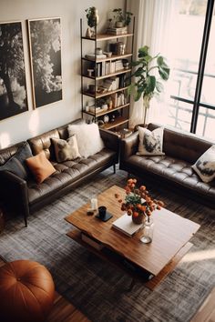 a living room with two couches, a coffee table and some pictures on the wall