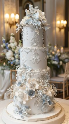 a three tiered white wedding cake with blue flowers