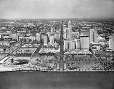 an aerial view of a large city with lots of tall buildings in the middle of it