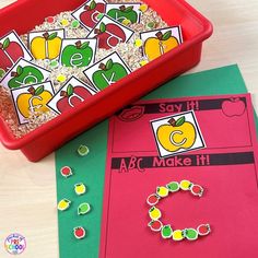 a red tray filled with lots of different items on top of a table