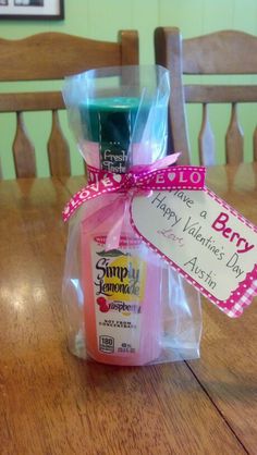 some kind of soap sitting on top of a wooden table next to a sign that says happy valentine's day