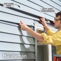 a man in yellow shirt and glasses fixing window sealer on the side of a house