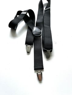 It's a Vintage great looking stylish unisex black elastic suspenders. With silver metal details. With metal clips. Adjustable. Condition: Great vintage condition. Material: Mixed. MEASUREMENTS:  Width: 1,5 inch / 4 cm. Worldwide shipping. Shipping takes to: USA 7-14 days.  EU 4-7 days. Others countries 7-14 days. Classic Black Belts And Suspenders For Party, Black Belts And Suspenders With Adjustable Straps, Formal Black Belts With Adjustable Strap, Fitted Black Belts And Suspenders For Party, Classic Black Belts And Suspenders With Adjustable Strap, Classic Black Belts And Suspenders For Black Tie, Classic Black Belt With Adjustable Strap, Elegant Black Belts And Suspenders With Adjustable Straps, Goth Belt