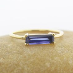 a gold ring with a blue stone on it