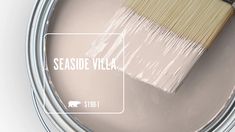 a paint can with a brush in it and the words seaside villa painted on it