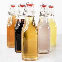 four bottles filled with different types of liquid