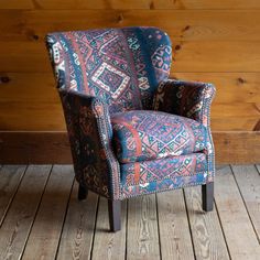 a blue and red chair sitting on top of a wooden floor