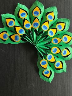 the paper peacock is made to look like it has its feathers spread out