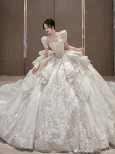 a woman in a white wedding dress is posing for the camera