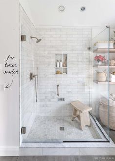 a walk in shower sitting next to a white wall and floor with shelves on each side