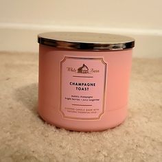 a pink candle is sitting on the floor