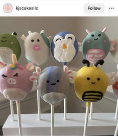 there are many cake pops with different faces on them