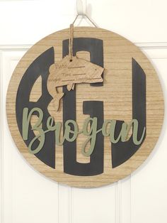 a wooden sign that says brogan hanging on a door