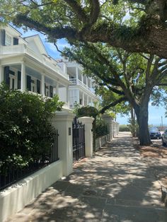 a street lined with white houses and trees