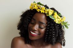 a woman with flowers in her hair smiling