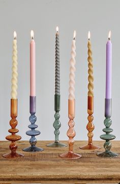 five candles are lined up in different colors