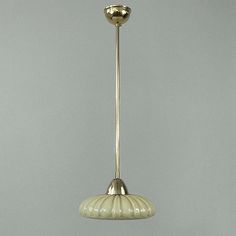 a light fixture hanging from the ceiling in a room with gray walls and flooring