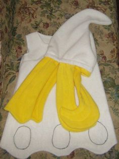 the towel is laying on top of the chair next to it's yellow and white cover