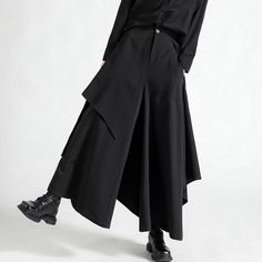 A pants skirt with an asymmetrical silhouette that looks like a skirt over wide pants. Although it has a dark atmosphere, it has a loose drape and a sophisticated and playful design. A leading item with an overwhelming presence. 
 
 
 ＜Size＞ 
 
 S size 
 
 Total length: 92cm 
 Waist: 64-68cm 
 
 M size 
 
 Total length: 93cm 
 Waist: 68-72cm 
 
 L size 
 
 Total length: 94cm 
 Waist: 72-76cm 
 
 XL size 
 
 Total length: 95cm 
 Waist: 76-80cm 
 
 
 
 
 
 
 
 
 
 
 
 
 
 
 
 ＜Material＞ 
 
 cotton Black Asymmetrical Hem Draped Skirt For Work, Black Draped Skirt With Asymmetrical Hem For Work, Black Asymmetrical Pleated Bottoms, Chic Irregular Fall Bottoms, Chic Irregular Bottoms For Fall, Asymmetrical Hem Pleated Skirt For Work, Chic Black Bottoms With Irregular Shape, Baggy Wide Leg Maxi Skirt For Fall, Black Loose Fit Wide Leg Maxi Skirt