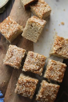 several pieces of cake sitting on top of a wooden cutting board