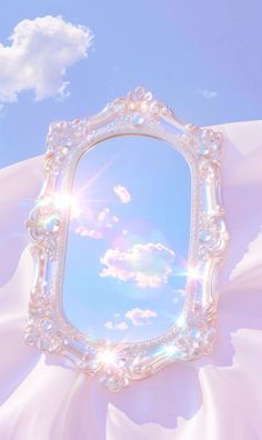 an ornate white frame with the sun shining through it and some clouds in the background