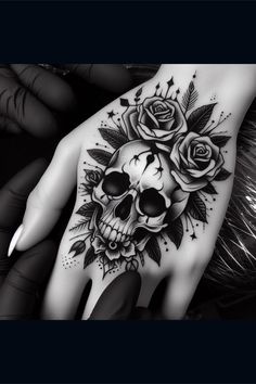 a hand with a skull and roses on it