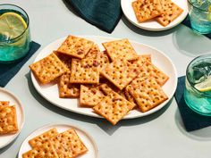 crackers on plates with lemon wedges and water