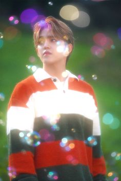 a young man standing in front of some bubbles