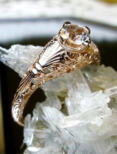 a close up of a ring on top of some crystals