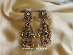 Three stone Temple Pearl Kundan Dangling temple earrings. Size : 3 approx inches Temple Style Bridal Brass Earrings For Festivals, Festive Heavy Temple Jewelry Earrings, Heavy Brass Temple Jewelry Bridal Earrings, Temple Jewelry Style Brass Danglers For Celebrations, Brass Temple Jewelry Bridal Earrings With Latkans, Brass Temple Jewelry Danglers For Celebrations, Temple Style Brass Danglers For Celebrations, Traditional Brass Earrings For Navratri, Temple Jewelry Style Danglers With Latkans For Ceremonial Use