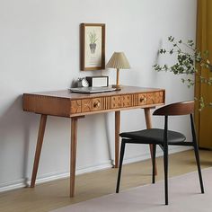 a wooden desk with two chairs next to it