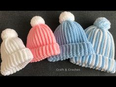 three knitted hats with pom - poms on them