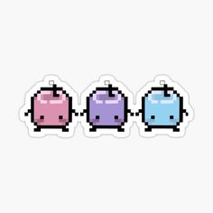 three different colored pacman stickers on a white background