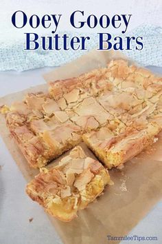 ooey gooey butter bars cut into squares and stacked on top of each other