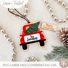 a christmas ornament with a tree in the back and merry christmas tag on top