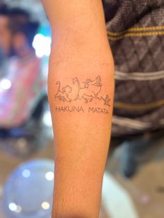 It has three of the main characters of the movie The Lion King
Character name
 Cub - SIMBA 
Warthog - Pumbaa
Meerkat - Timon Simba Timon And Pumba Tattoos, Timon Pumba Simba Tattoo, Timone Pumba Tattoo, Loin King Tattoos, A Kuna Matata Tattoo, Lion King Quote Tattoos, Disney Tattoos Lion King, Small Lion King Tattoo, Simba Tattoo Lion King