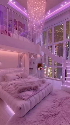 a large white bed sitting in a bedroom under a chandelier with purple lights