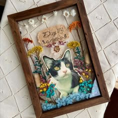 there is a picture of a black and white cat in a frame on the table