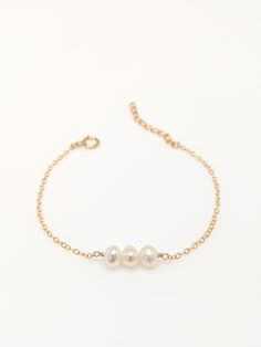 "Our gift to you 10% off your first purchase. Details here - http:/eepurl.com/dpVPBz You have found the perfect dainty pearl bracelet. Available with 1, 2 or 3 pearls. Personalize the number of pearls with your wishes, goals, children etc. Perfect for that special occasion yet simple enough for every day wear. You and your loved one will adore this meaningful gift. DETAILS 14 k fill or Sterling Silver. Choose 1, 2 or 3 pearls. Each fresh water pearl is unique, meaning the size and shape may vary