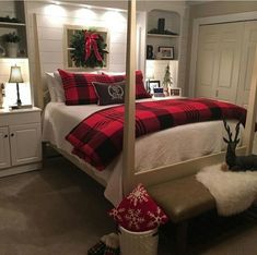 a bedroom with a four poster bed and christmas decorations