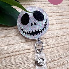 a retractable badge holder with a jack skellingy face on the front