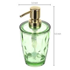 a green glass soap dispenser with gold accents and a metal spout