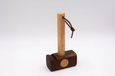 a small wooden object with a rope on it's end and a piece of wood sticking out of the top