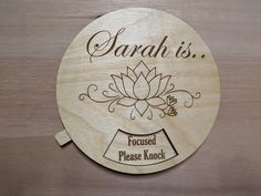 a wooden plaque that says, sarah is focused please knock on the front of it