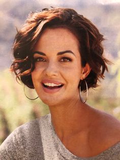 Assymetrical Bob Wavy Hair, Curly Bob With Straight Bangs, Short Cuts For Wavy Hair Over 50, Chin Length Wavy Bob With Bangs, Trendy Short Hair Styles 2023, Short Wavy Hair Oval Face, Pixie Wavy Haircut, Curly Pixie Bob Haircut, Short Hairstyle Women Wolf Cut