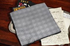 Elevate your style with this luxurious black Glen plaid silk pocket square. Featuring a timeless pattern that effortlessly adds texture and sophistication, this classic accessory is perfect for the discerning gentleman. The black rolled border enhances its sleek design, making it a versatile addition to any blazer or suit jacket. Measuring 16 inches by 16 inches, it's perfectly sized to fold in multiple ways, allowing you to create the perfect finishing touch for any formal or smart-casual outfit. New condition, no tags or maker label. Please review the photos for further assessment. Whether you're dressing for a special occasion or adding a touch of refinement to your everyday look, this pocket square is a must-have for your collection. Black Formal Pocket Square, Black Pocket Square For Formal Occasions, Classic Pocket Square For Black-tie Events, Classic Black Pocket Square For Business, Classic Black Pocket Square, Elegant Black Handkerchiefs For Business, Elegant Black Business Handkerchiefs, Classic Rectangular Pocket Square For Business, Classic Black Formal Handkerchiefs