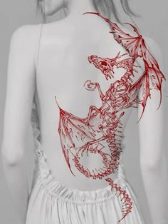 the back of a woman's body with red dragon tattoos on her upper half